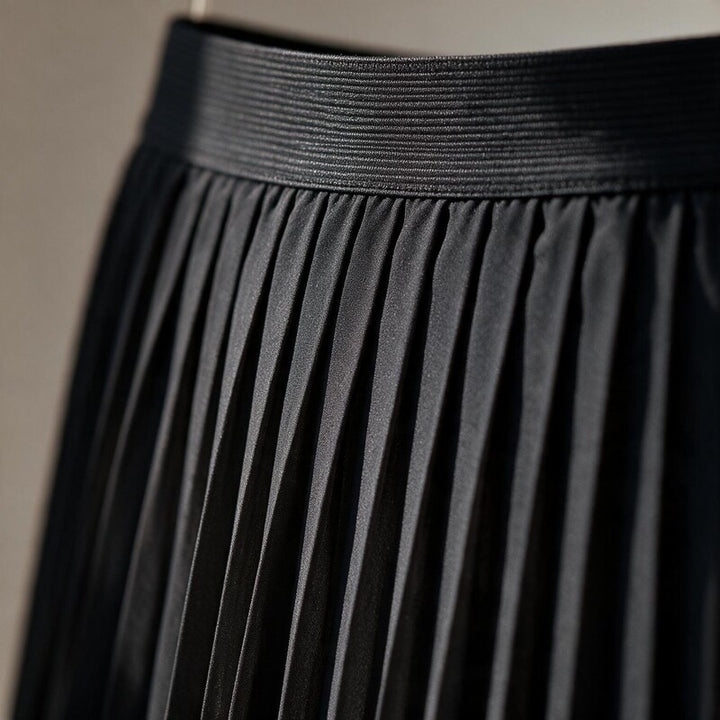 Lucy Melbourne pleated midi skirt in Black – close-up detail of waistband and pleats