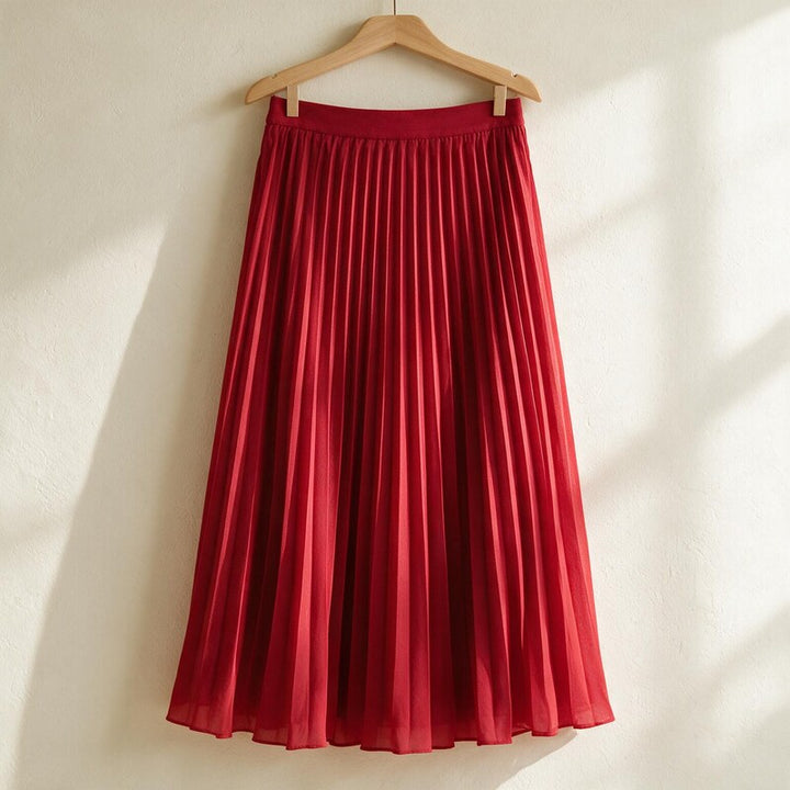 Lucy Melbourne pleated midi skirt in Red – hanging on a wooden hanger