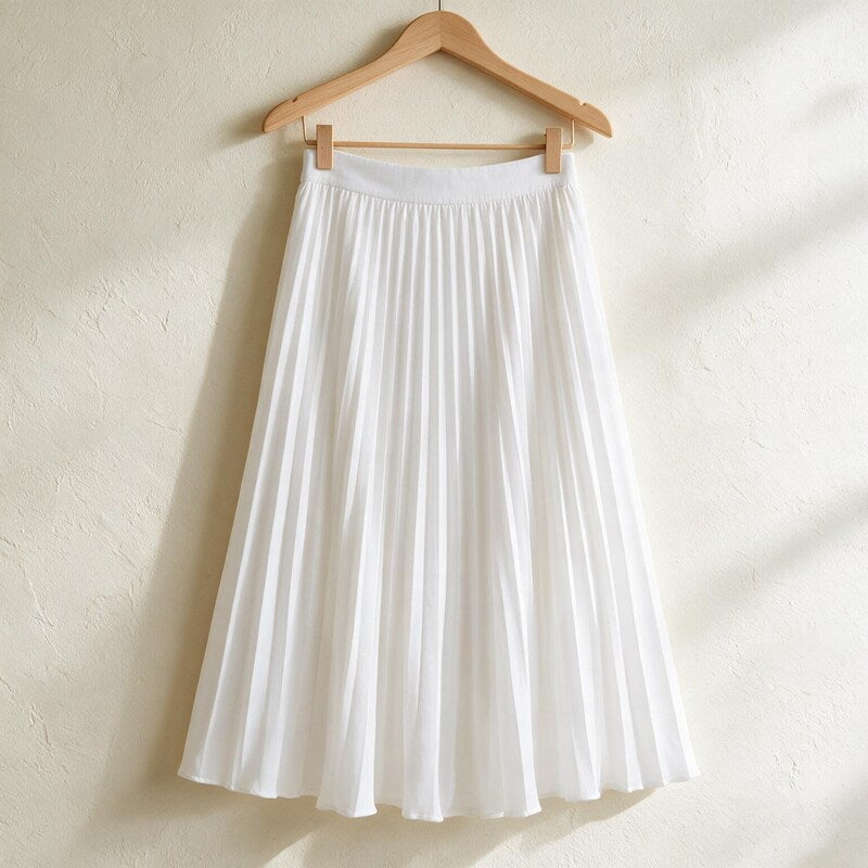 Lucy Melbourne pleated midi skirt in White – hanging on a wooden hanger